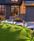 Solar Pathway Lights Outdoor 6 Pack LED Waterproof Conical Garden Stakes illuminating a driveway with bronze finish landscape lighting