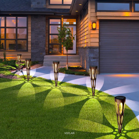 Solar Pathway Lights Outdoor 6 Pack LED Waterproof Conical Garden Stakes illuminating a driveway with bronze finish landscape lighting