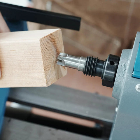 Close-up of Morse Taper 2 Wood Lathe Live Center and Drive Center Set 4 Pc Cup Kit in use, showing wood block on lathe for turning.