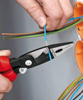 Person using Electrical Installation Pliers 6 In 1 Multi Function Tool with red handles and black finish for electrical wiring.
