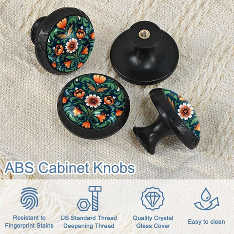 Norwegian Rosemaling Green Flower Cabinet Knobs Set with black base and floral design on fabric background.