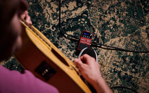 Musician with guitar using RC-5 Loop Station High Resolution 32-Bit AD/DA and 32-Bit Float Processing Looper For Stereo Recording Up To 13 Hours Of Jam Time LCD With Multicolor Backlight For Clear Loop Status And Quick Onboard Control.