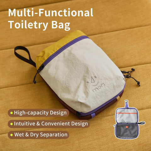Water Resistant Travel Toiletry Bag With Hidden Carabiner Hook And Hanging Loop for gym and bathroom storage on tan surface.