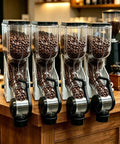 Built Different Coffee Bean Dispenser With See Through Acrylic Hopper Bulk Storage For Commercial Buffets And Home Bars Easy Access Flip Lid Cereal Canister Four Pack Deal with four hoppers filled with coffee beans.