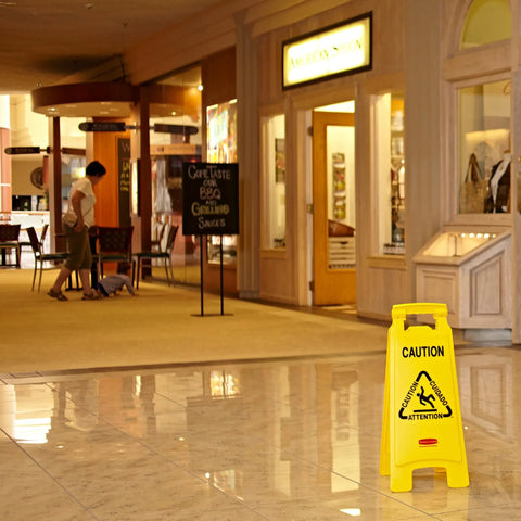 26 Inch Heavy Duty Yellow Caution Sign For Slip Hazards And Wet Floors Twin Sided High Visibility Standup Floor Sign in mall hallway.