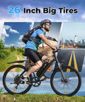 Power Packed 500W Peak Electric Bike For Adults With Up To 60 Mile Range Removable Battery 20 MPH Assist 7 Speed Gearing 26 Inch Tires Shock Absorber Slick Commuter E Bike rider on 26-inch tires on trail and city road