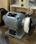 Grind Ready Buffing Wheels For Bench Grinders Set Of Two Six Inch Pads Half Inch Center Hole mounted on a bench grinder.
