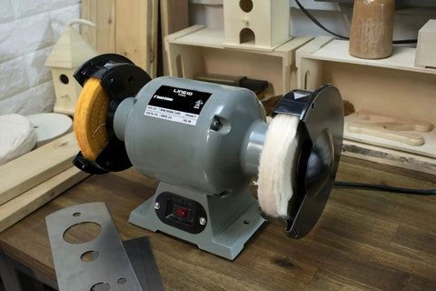Grind Ready Buffing Wheels For Bench Grinders Set Of Two Six Inch Pads Half Inch Center Hole mounted on a bench grinder.