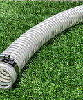 1.5 Inch Pool Replacement Hose For Above Ground Pools, flexible PVC vinyl, resting on grass, with UV resistant design and metal clamp