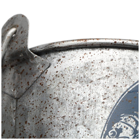 Close-up of vintage style metal bucket edge, rustic speckled finish, detail view of fishing-inspired garage decor storage pail.