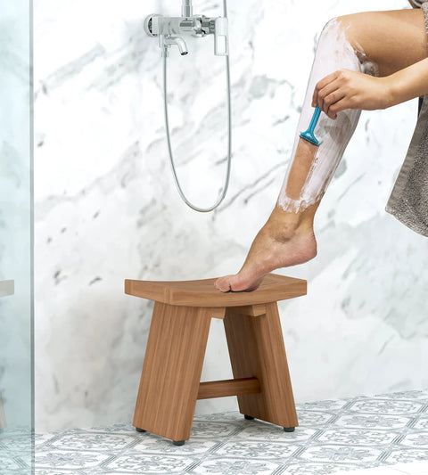 Person using 13 Inch Solid Teak Wood Shower Foot Bench With No Slip Rubber Gripping Feet Stainless Hardware And Water Resistant Indoor Outdoor Built To Last Spa Ready Foot Rest in shower.