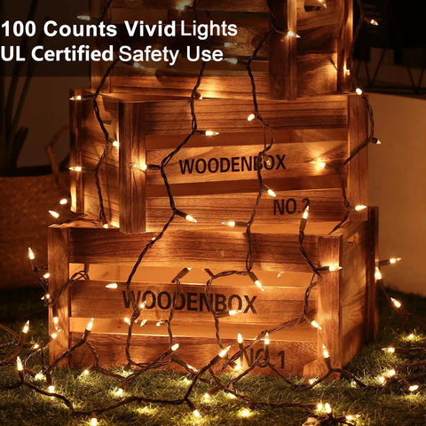 Clear Christmas Lights String With Brown Wire 21 Feet Long 100 Incandescent Bulbs Warm White Glow wrapped around wooden crates