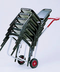 Raymond 500 Stacked Chair Dolly For Event Venues with stacked chairs, sturdy steel frame, and red handle for easy transport.