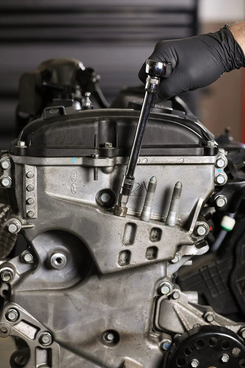 Hand using Turbo Socket Set For Damaged Bolt Extraction, 18-Piece One Quarter Inch Drive Kit on engine bolt