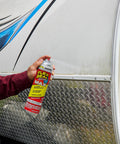 Applying Two Pack 17 Oz Clear Rubber Sealant Spray That Stops Leaks Instantly on camper exterior.