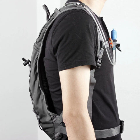 Side view of person wearing Hydration Pack Backpack With 70 Oz Water Bladder For Running Hiking Cycling Climbing Camping And Biking Featuring Adjustable Straps