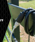 Heavy Duty 12/3 25 Foot Extension Cord For Farm And Shop Use All Copper Wire SJTOW Weather Rated Extra Durable Molded Plug Cold Weather Ready From -58F To 221F Black coiled on a fence outdoors