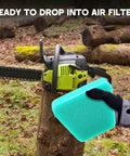 Gloved hand holding air filter next to chainsaw, part of Air Filter Fuel Line Primer Bulb Spark Plug Tune Up Kit For 42cc Poulan Craftsman Chainsaws.