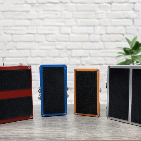 Colorful guitar and bass pedals secured with Grip Kit For Pedalboards With 10 Feet Of Heavy Duty Hook And Loop Tape And 6 Reusable Cable Ties
