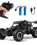 One Sixteenth Scale All Terrain RC Monster Truck With LED Headlights 2WD Off Road High Speed Remote Control Car shown with controller and batteries