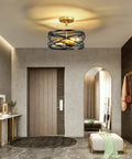 Modern industrial farmhouse drum cage style semi flush mount ceiling light fixtures with two lights, black and gold finish in hallway.