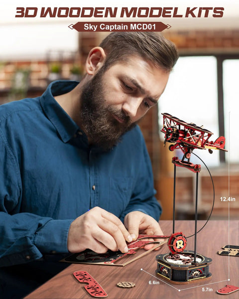 Man assembling 3D Wooden Puzzle For Grownups Gravity Swing Model Kit 163 Piece Set Recreating A Classic Biplane Gladiator