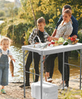 42.5 Inch Folding Fish Cleaning Table With Sink And Hose Hookup Portable Outdoor Fishing Station being used by a family