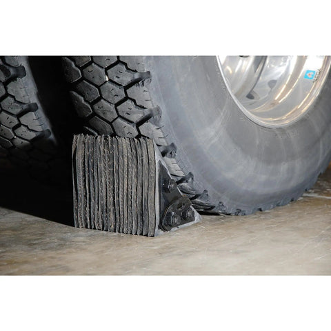Built Tough Laminated Wheel Chock 8 Inch By 8 Inch By 8 Inch For Trucks And Trailers With Welded Ring in use with a truck tire