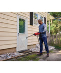 Man using Cordless Pressure Washer Spray Gun Kit With 350 Max PSI, Extension, Soap Bottle, Battery And Charger Included on house exterior