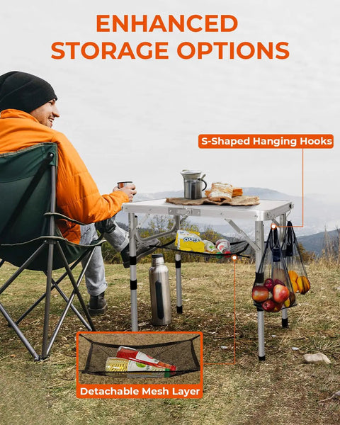 Person using Adjustable Camping Table Folding Lightweight 5Lb Table with S-hooks and mesh shelf for outdoor dining.