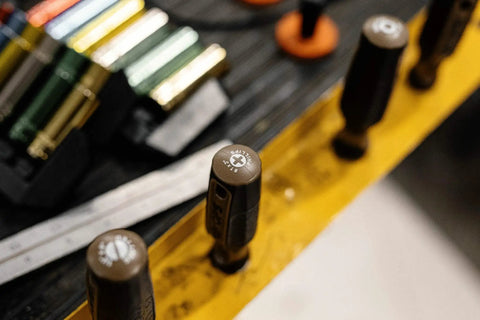 Pro Grade Phillips Screwdriver Size 2 By 4 Inch With Magnetic Cr Mo Steel Blade Heat Treated Antislip Grip on a workbench.