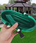 Person holding Flat Soaker Hose With Perforated Holes For Even Yard Watering Flexible PVC Low Profile Sprinkler Hose 7.5m