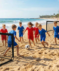 Children playing soccer on a beach with a Backyard Pop Up Soccer Goals Set of 2 for Kids, 4x3ft Training Nets With Soccer Ball, Black.