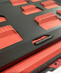 Close-up of Milwaukee Packout Wall Mounting Plate Dope Metal Base for Toolboxes on black and red storage unit