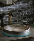Bathroom Vessel Sink Vintage Hand Engraving Skirted Vessel, Ceramic Round Sink on a stone countertop with faucet.