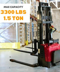 Industrial Grade Electric Straddle Stacker Rated For 3300 Lb Capacity With 157 Inch Lift in a warehouse setting.