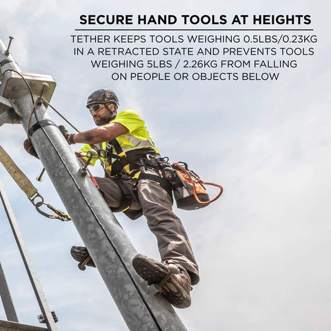 Worker using the Squids 3011 Retractable Tool Lanyard with Carabiner Mount for safety while securing tools at height.