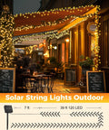 Two Pack 92Ft 240 LED Solar String Lights Outdoor Waterproof With Eight Modes For Patio Garden Yard Tree Decor Warm White No Outlet Needed Weatherproof And Easy To Set Up For Parties illuminating a cafe facade.