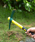 Alt Tag: 15 Inch Pick Mattock Hoe With Forged Steel Head And Fiberglass Handle For Digging And Loosening Soil in grassy area