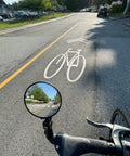 Big Bar End Mirror For E Bikes With Automotive Grade Glass Delivers Crystal Clear View On Left Or Right Fits Most 14.8 To 23 Mm Handlebars showing road view.