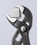 Cobra Water Pump Pliers 6 Inch with self locking teeth gripping a metal cube, showcasing 11 adjustable positions, and pinch guard.