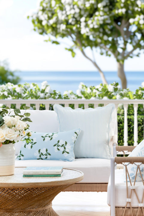 Outdoor setting with Coastal Throw Pillow Cover With Scalloped Edge, Water Repellent 20x20 Inches, Baby Blue Stripes on wicker couch