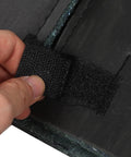 Close-up of hand holding black adhesive strip for Self Adhesive Soundproof Foam Board For Outdoor Air Conditioner Units 11X25 Inch.