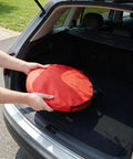 Person placing 3 In 1 Golf Chipping Net Set With Pop Up Targets 12 Inch 18 Inch And 24 Inch into car trunk for storage