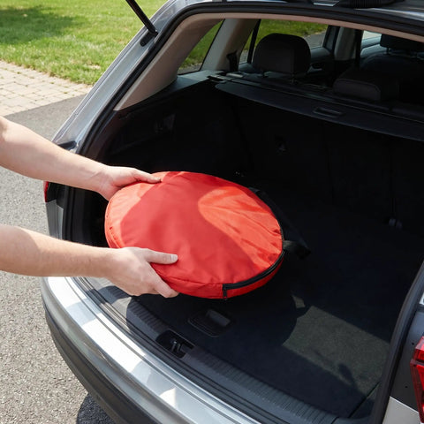 Person placing 3 In 1 Golf Chipping Net Set With Pop Up Targets 12 Inch 18 Inch And 24 Inch into car trunk for storage