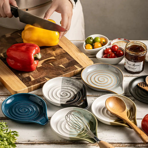 Assorted ceramic spoon rests on kitchen counter with chopping board and peppers, showcasing Porcelain Spoon Rest And Drip Tray For Multiple Utensils On The Stovetop Huge Capacity Go To Utensil Holder For Spoons Ladles Tongs And Spatulas Black Farmhouse Kitchen Decor