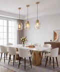 3 Pack Gold Pendant Lights For Kitchen Island Featuring 8.7 Inch Hand Blown Clear Art Glass Globes above a modern dining table
