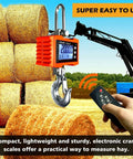 Beefy Digital Crane Scale With 1000 Kg Capacity 2200 Lb High Precision 0.2 Kg Increments Aluminum Case Remote Control hanging in field.