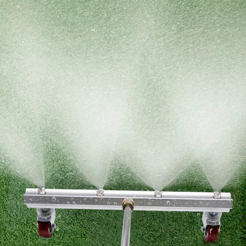 Detail of Grime Busting 16 Inch Pressure Washer Undercarriage Cleaner spraying water on grass