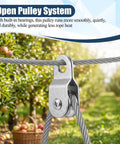 Open Pulley System Snatch Block With Bearing for Smooth Rope Feeding mounted on steel cable in an orchard
